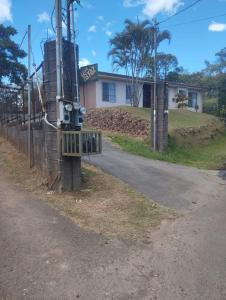 a road in front of a house with a fence at YayazNature Lodge in Grecia +2 photos