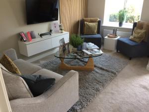 a living room with a couch and a coffee table at Waverley 3-Bed Springfields House in Rotherham