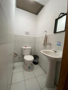a bathroom with a toilet and a sink at Mía Leticia B&B in Quito +56 photos