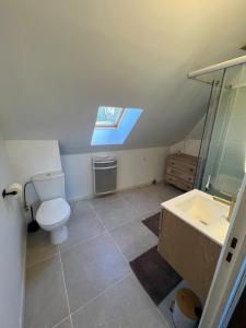 a bathroom with a toilet and a sink and a window at appartement de charme in Pont-Sainte-Marie
