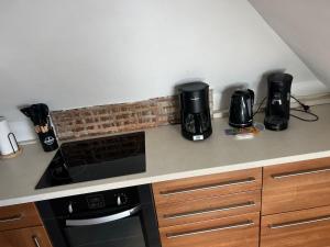a kitchen counter with two coffee makers and a stove at appartement de charme in Pont-Sainte-Marie
