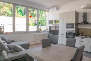 a kitchen and living room with a table and chairs at Cernobbio Apartment in Cernobbio +11 photos
