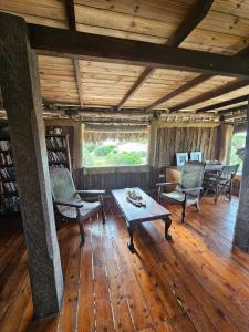 a living room with chairs and a coffee table at Bone Idle, Lamu Beach Home in Lamu