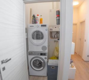 a laundry room with a washer and dryer at Cernobbio Apartment in Cernobbio