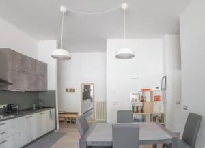 a kitchen with a table and chairs in a room at Cernobbio Apartment in Cernobbio