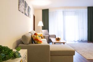 a living room with a couch and a chair at Rotunda 309 in Dunajská Streda
