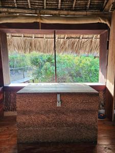 a window in a straw roofed room with a view at Bone Idle, Lamu Beach Home in Lamu +87 photos