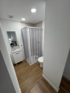 a bathroom with a toilet and a sink at Alma in La Canyera +15 photos
