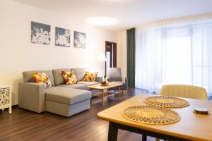 a living room with a couch and a table at Rotunda 309 in Dunajská Streda