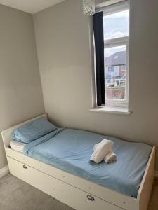 a small bedroom with a bed with a window at Cosy 2 Bed By Pleasure Beach in Blackpool