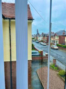 a view from a window of a street with houses at Cosy 2 Bed By Pleasure Beach in Blackpool