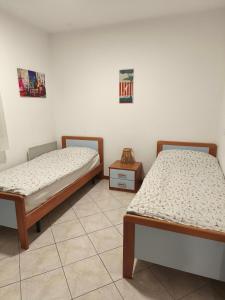 two beds sitting next to each other in a room at Volme home in Banjole