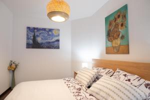 a bedroom with a bed and a painting on the wall at Rotunda 309 in Dunajská Streda