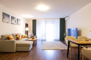 a living room with a couch and a table at Rotunda 309 in Dunajská Streda +9 photos