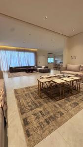 a large living room with tables and a couch at فلو بارك in Unayzah