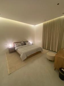 a white bedroom with a large bed and a window at فلو بارك in Unayzah +40 photos