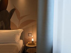a bedroom with a bed and a candle on a table at Etna Stone Rooms in Zafferana Etnea