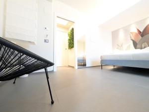 a bedroom with a bed and a bench in it at Etna Stone Rooms in Zafferana Etnea