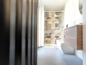 a bathroom with a shower and a sink and a toilet at Etna Stone Rooms in Zafferana Etnea