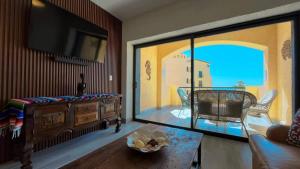 a living room with a view of a living room with a tv at Gorgeous Third-Level Condo Princesa D-308 in Puerto Peñasco