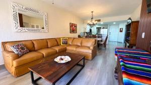 a living room with a couch and a table at Gorgeous Third-Level Condo Princesa D-308 in Puerto Peñasco