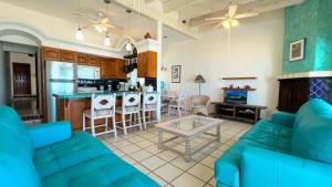 a living room with a couch and a table at Charming and Cozy Beachfront Condo - Las Olas II 3 in Puerto Peñasco +16 photos