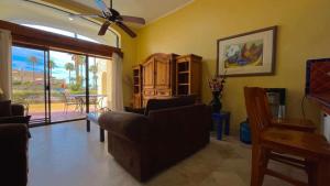 a living room with a couch and a table at Cozy Ground Level Condo near Pool Pinacate 112 in Puerto Peñasco