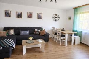 a living room with a couch and a table at Ferienwohnung Panoramablick Bermersbach in Forbach