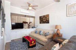 a living room with a couch and a flat screen tv at Cozy Beachfront Condo Las Olas II 10 in Puerto Peñasco