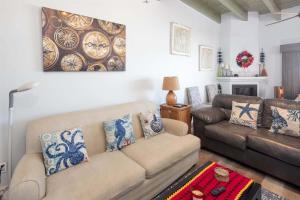 a living room with a couch and a table and a painting at Cozy Beachfront Condo Las Olas II 10 in Puerto Peñasco +37 photos
