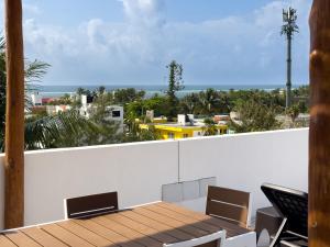 a view from the balcony of a house with a table and chairs at Casa Alba in Puerto Morelos