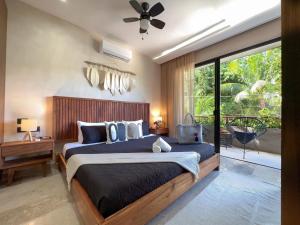 a bedroom with a large bed and a large window at Casa Alba in Puerto Morelos +56 photos