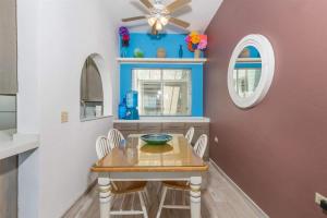 a dining room with a table and a ceiling fan at Cozy & Beautiful Beachfront Condo Las Olas II 2 in Puerto Peñasco