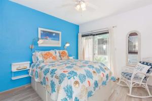 a blue bedroom with a bed and a chair at Cozy & Beautiful Beachfront Condo Las Olas II 2 in Puerto Peñasco +22 photos