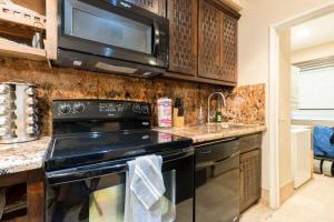 a kitchen with a stove and a microwave at Unique Oceanfront with Epic Sunsets Pinacate 202 in Puerto Peñasco
