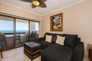 a living room with a couch and a ceiling fan at Unique Oceanfront with Epic Sunsets Pinacate 202 in Puerto Peñasco