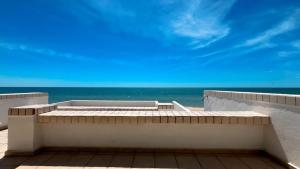 a balcony with a view of the ocean at Warm & Charming Beachfront Condo Las Olas II 8 in Puerto Peñasco