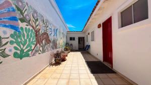 a hallway of a building with a painting on the wall at Warm & Charming Beachfront Condo Las Olas II 8 in Puerto Peñasco