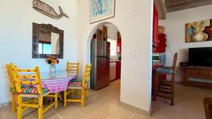 a kitchen and dining room with a table and chairs at Warm & Charming Beachfront Condo Las Olas II 8 in Puerto Peñasco +20 photos