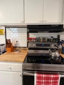 a kitchen with a stove with a pot on it at The Holler in Andrews