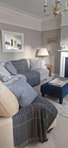 a living room with two couches and a couch at Rockleigh House in Corsham