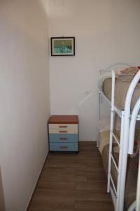 a bedroom with two bunk beds and a wooden floor at Tropical House in Formia