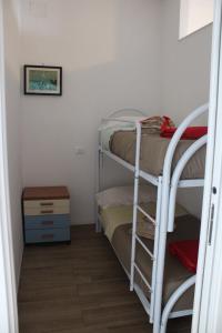 a room with two bunk beds in a room at Tropical House in Formia