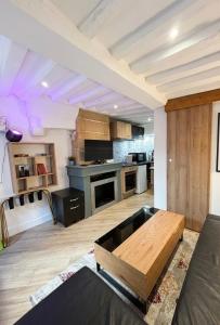 a large kitchen with a table in the middle at L 'iris, studio Hyper-centre, rue Arcisse de caumont, nouvelle equipe d entretien in Caen