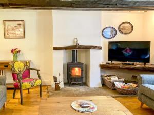 a living room with a fireplace and a stove at Brook House 1 - Uk1415 in Bassenthwaite
