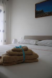 a pile of towels sitting on a bed at Tropical House in Formia