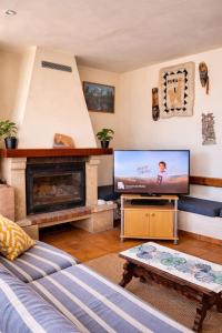 a living room with a fireplace and a flat screen tv at Cala Paradiso in Tossa de Mar