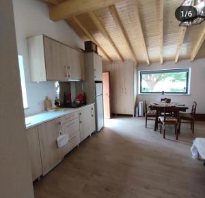 a large kitchen with a table and a dining room at Casa da Eira in Pinheiro de Coja