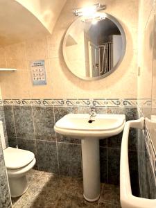 a bathroom with a sink and a mirror at Cala Paradiso in Tossa de Mar +17 photos