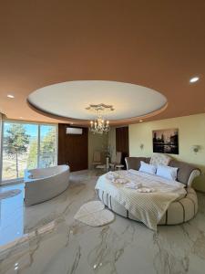 a bedroom with a large bed and a bath tub at Safi in Dospat